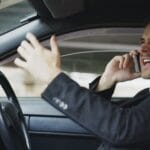 Zdenerwowany mężczyzna rozmawia przez telefon w samochodzie